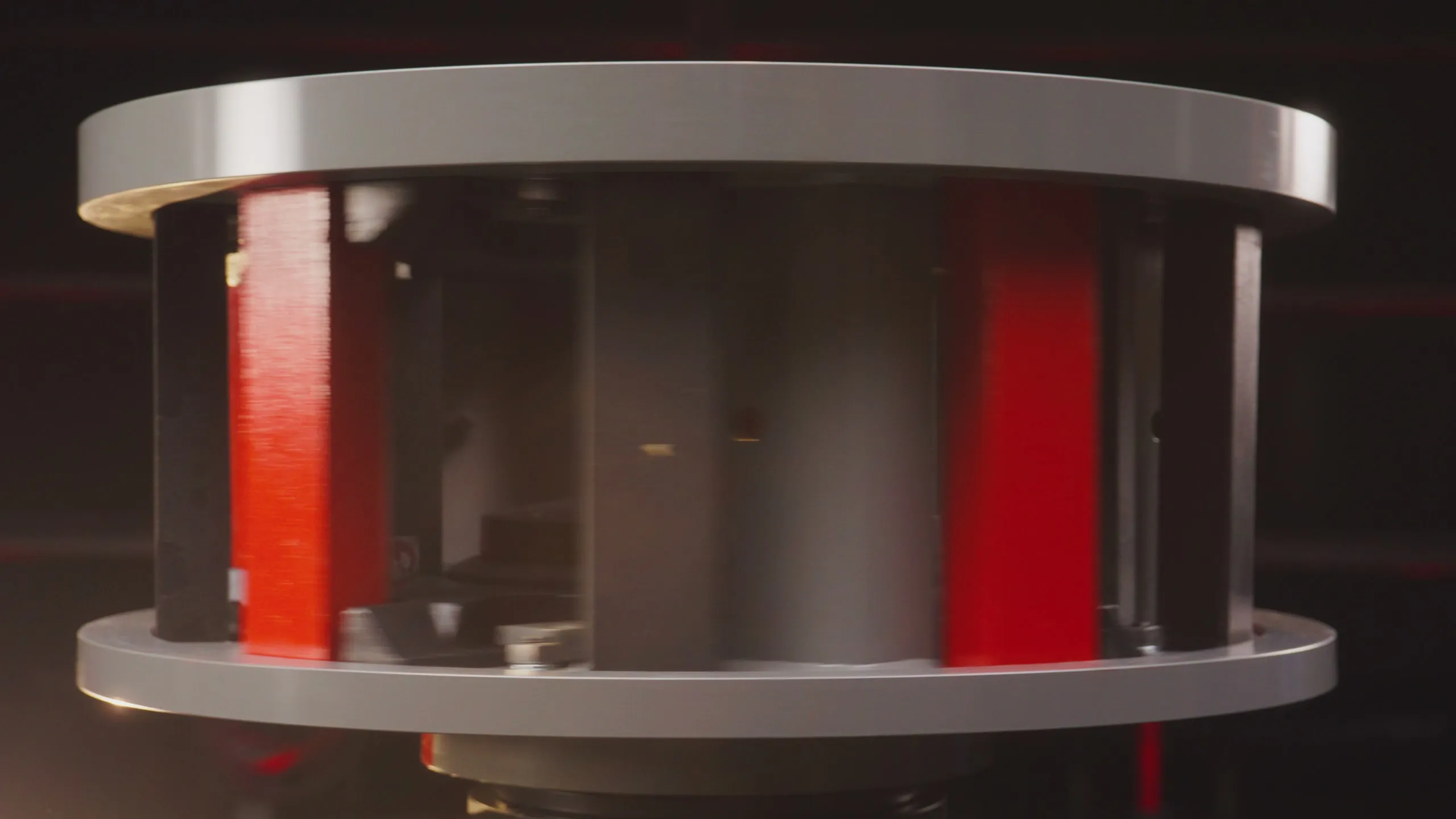 Rhino VSI rotor under studio lighting, red wear tips visible between the plates